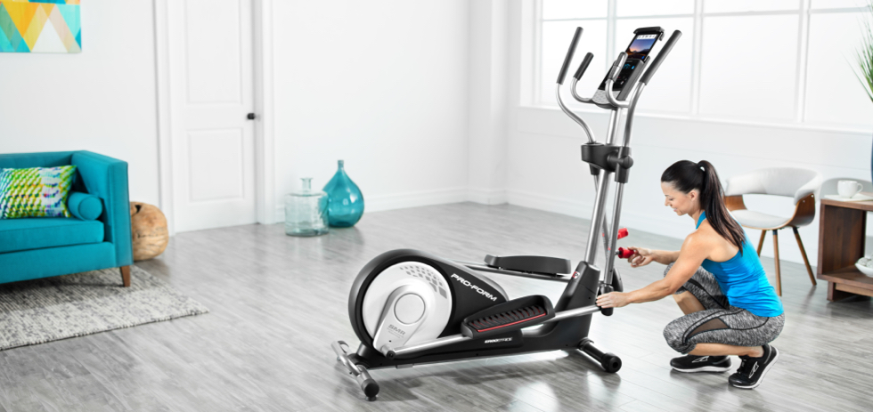woman cleaning a proform elliptical