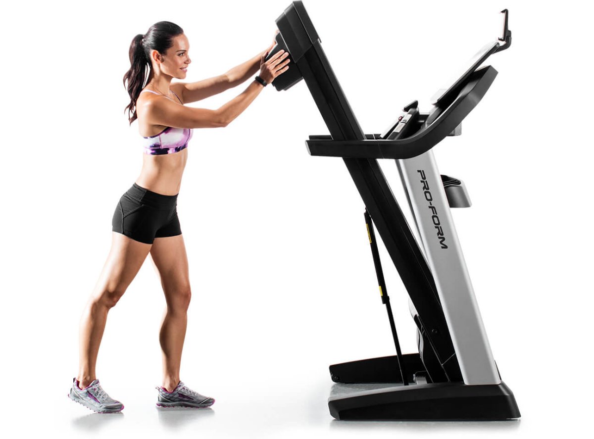 Treadmill in space-saving position with superimposed image of the various stages of the space-saving process
